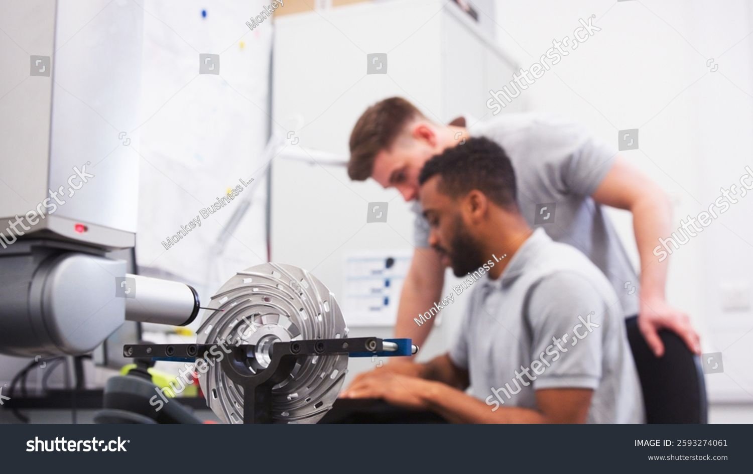 stock-photo-two-male-engineers-uses-cmm-coordinate-measuring-machine-in-factory-with-focus-on-foreground-2593274061